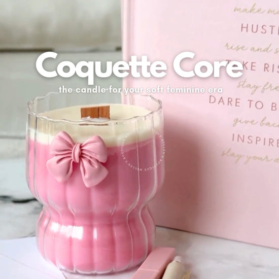 Decorative Ripple Glass cup with pink bow on it filled with a pink candle with wood wick.